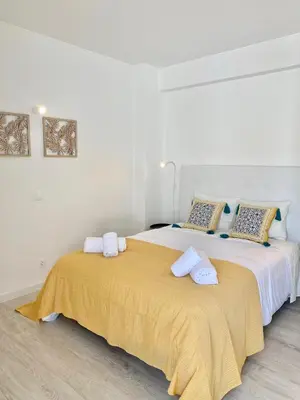 a bedroom with two beds with towels on them at White Sand Apartments Downtown Albufeira in Albufeira