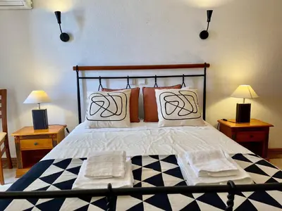 a bedroom with a large bed with two lamps on tables at Villa Cristina 9 in Albufeira