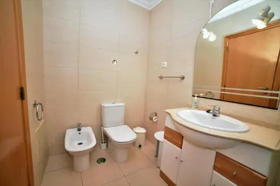 a bathroom with a toilet and a sink at Sandy Beach apartment in Albufeira