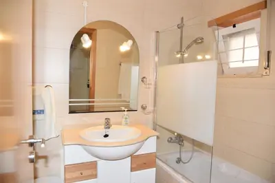 a bathroom with a sink and a shower at Sandy Beach apartment in Albufeira