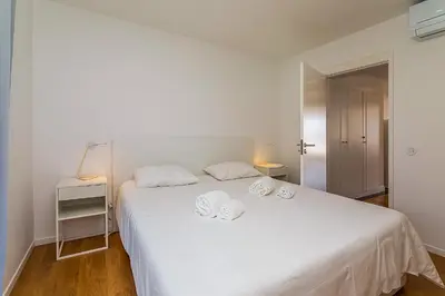 a bedroom with a white bed with two towels on it at Vista dos Seus Sonhos T2 HsR Vilamarina in Vilamoura