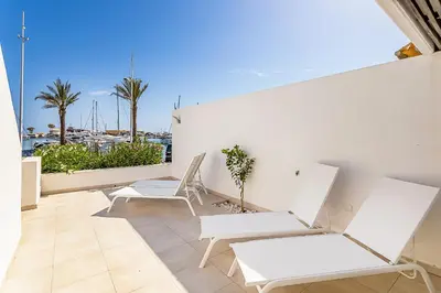 a balcony with white chairs and a view of a harbor at Vista dos Seus Sonhos T2 HsR Vilamarina in Vilamoura