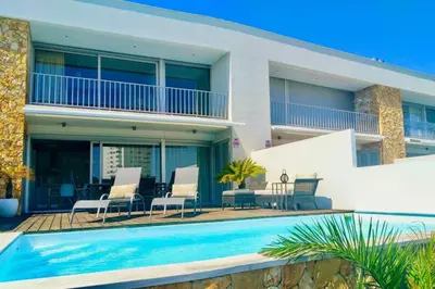 a house with a swimming pool in front of it at Villa Ray Design in Albufeira