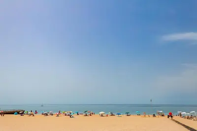 a group of people on a beach with umbrellas at Casa da Praia dos Pescadores in Albufeira