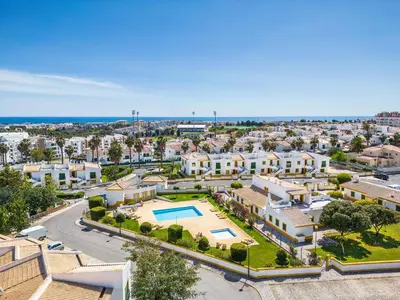 an aerial view of a city with houses and a pool at Nuances do Oceano by OCvillas in Albufeira