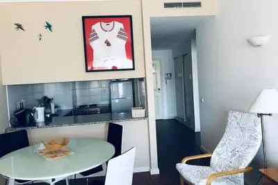 a kitchen with a table and a table and chairs at Vacations home Albufeira in Albufeira
