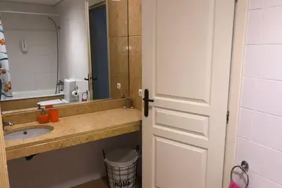 a bathroom with a sink and a mirror and a door at Vacations home Albufeira in Albufeira