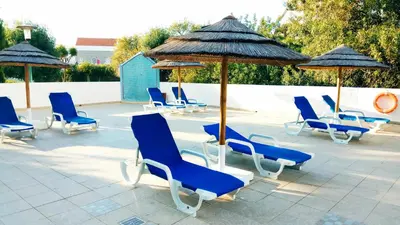 a group of blue chairs and umbrellas on a patio at Albufeira 603 in Albufeira