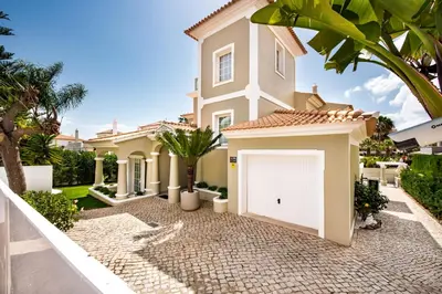 a house with a white garage at Rosal 27 by Algarve Villa Holidays in Albufeira