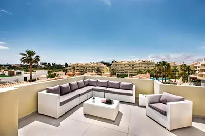 a balcony with two couches and a coffee table at Rosal 27 by Algarve Villa Holidays in Albufeira