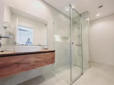 a bathroom with a sink and a glass shower at Vila Hibisco by Garvetur in Vilamoura