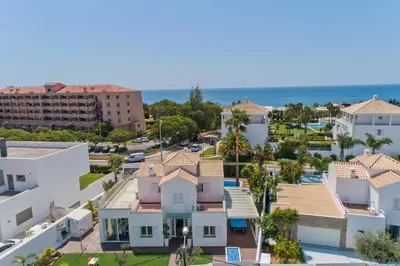 an aerial view of a city with houses and the ocean at Villa Maresia Dourada in Guia