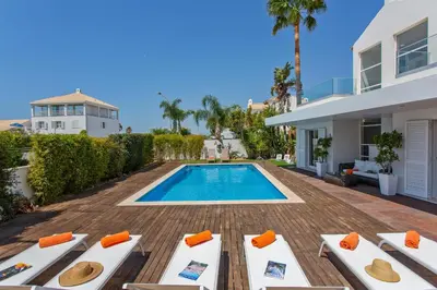 a villa with a swimming pool and a house at Villa Maresia Dourada in Guia