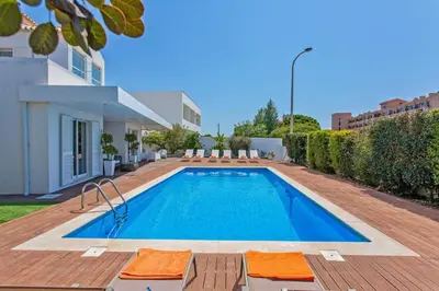 a swimming pool in the backyard of a house at Villa Maresia Dourada in Guia