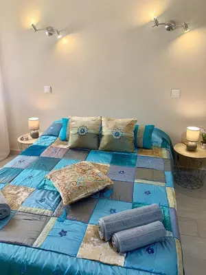 a large blue bed with pillows on it in a room at 125 Oliveiras Terraces in Albufeira