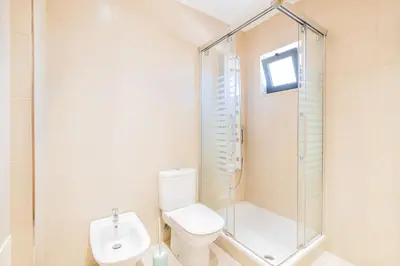 a bathroom with a shower and a toilet and a sink at Cozy villa with pool and Barbecue in Albufeira