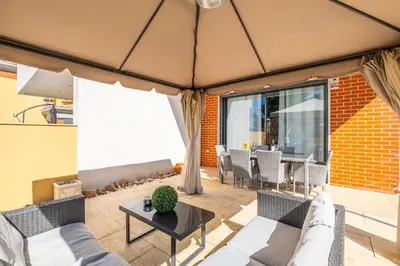 a living room with a couch and a table at Cozy villa with pool and Barbecue in Albufeira