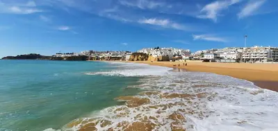 a view of a beach with buildings in the background at Velha 34 in Albufeira