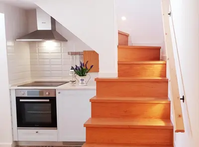 a kitchen with a staircase with a stove at Velha 34 in Albufeira