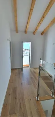 a room with a glass table and a doorway at Velha 34 in Albufeira