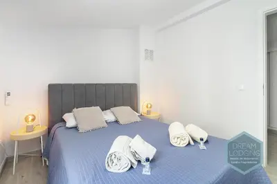 a bedroom with a blue bed with towels on it at Old Town - Albufeira - Dream Lodging in Albufeira