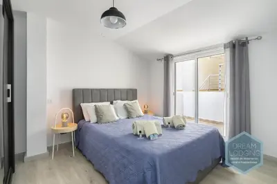 a bedroom with a blue bed with two pillows on it at Old Town - Albufeira - Dream Lodging in Albufeira