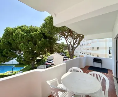 a balcony with a table and chairs and a view of a street at Alvaflor - Vilamoura in Vilamoura