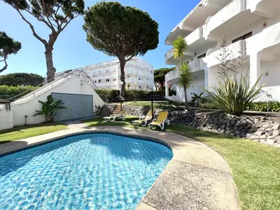 a swimming pool in the yard of a building at Alvaflor - Vilamoura in Vilamoura