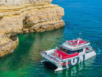 a boat in the water next to a beach at V4, Villa Jardins Branqueira near Beach, Albufeira in Albufeira