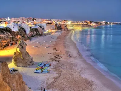a group of people on a beach near the ocean at V4, Villa Jardins Branqueira near Beach, Albufeira in Albufeira