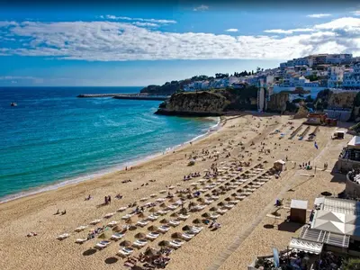 a beach with umbrellas and people on the beach at V4, Villa Jardins Branqueira near Beach, Albufeira in Albufeira