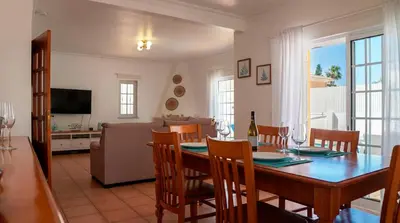 a living room with a blue couch and a coffee table at Villa do Mar - Galé in Albufeira