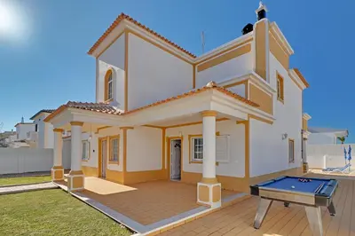 a swimming pool in front of a house at Villa do Mar - Galé in Albufeira