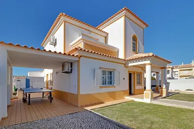 a house with a ping pong table in front of it at Villa do Mar - Galé in Albufeira