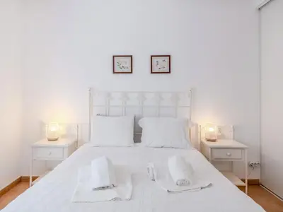 a bedroom with a white bed with two white tables at Villa Villa Monte da Torre by Interhome in Loulé