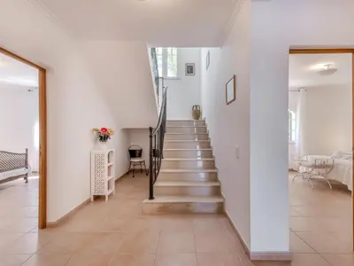 a staircase in a home with white walls and tile floors at Villa Villa Monte da Torre by Interhome in Loulé
