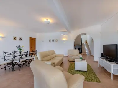 a living room with white furniture and a flat screen tv at Villa Villa Monte da Torre by Interhome in Loulé