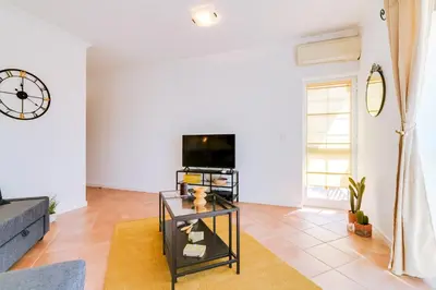 a living room with a couch and a tv at The Nest Apartment - Sea View - Faro in Faro