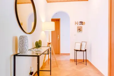 a hallway with a table and a mirror at The Nest Apartment - Sea View - Faro in Faro