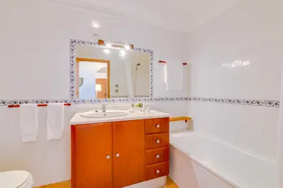 a bathroom with a sink and a tub and a toilet at The Nest Apartment - Sea View - Faro in Faro