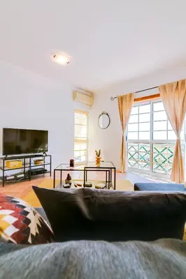 a living room with a couch and a tv at The Nest Apartment - Sea View - Faro in Faro