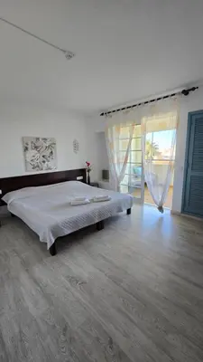 a bedroom with a large bed and a large window at Sea view Penthouse 10 min walking Albufeira old town and Beach Pescadores in Albufeira