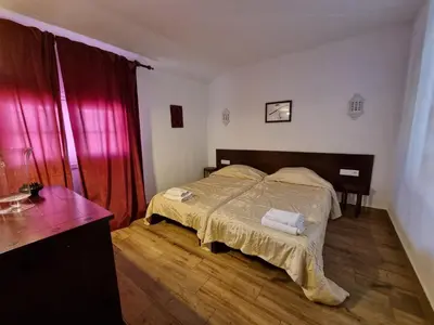 a bedroom with a bed and a wooden floor at Sea view Penthouse 10 min walking Albufeira old town and Beach Pescadores in Albufeira