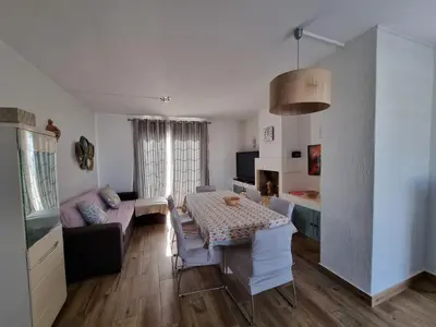 a living room with a table and a couch at Sea view Penthouse 10 min walking Albufeira old town and Beach Pescadores in Albufeira