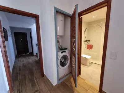 a laundry room with a washing machine and a bathroom at Sea view Penthouse 10 min walking Albufeira old town and Beach Pescadores in Albufeira