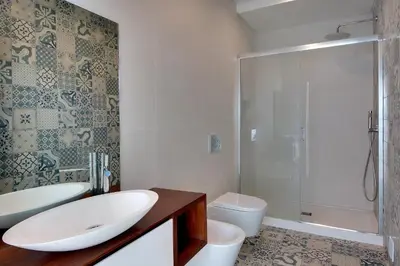 a bathroom with a tub and a toilet and a shower at Casa da Bandeira -Perfect Location-Beach front- Rooftop Pool by DreamvillasAlbufeira in Albufeira