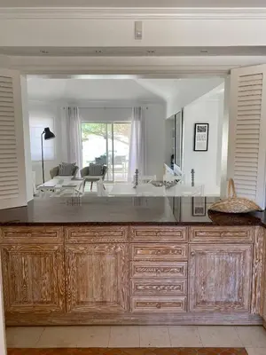 a large kitchen with a large mirror and a sink at Beautiful apartment for rent in Quinta do Lago with excellent resort facilities close to lake and beach. in Quinta do Lago