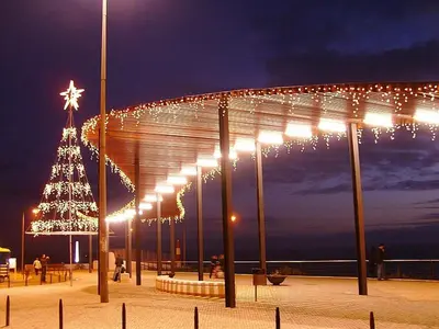a christmas tree on a pier with lights at 