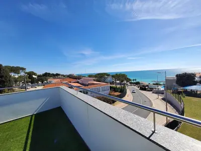 a balcony with a view of a road and the ocean at 