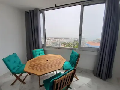 a white bedroom with a bed and a fan at Vista Praia 16- Wifi, Remodelado, 80mt Praia in Quarteira